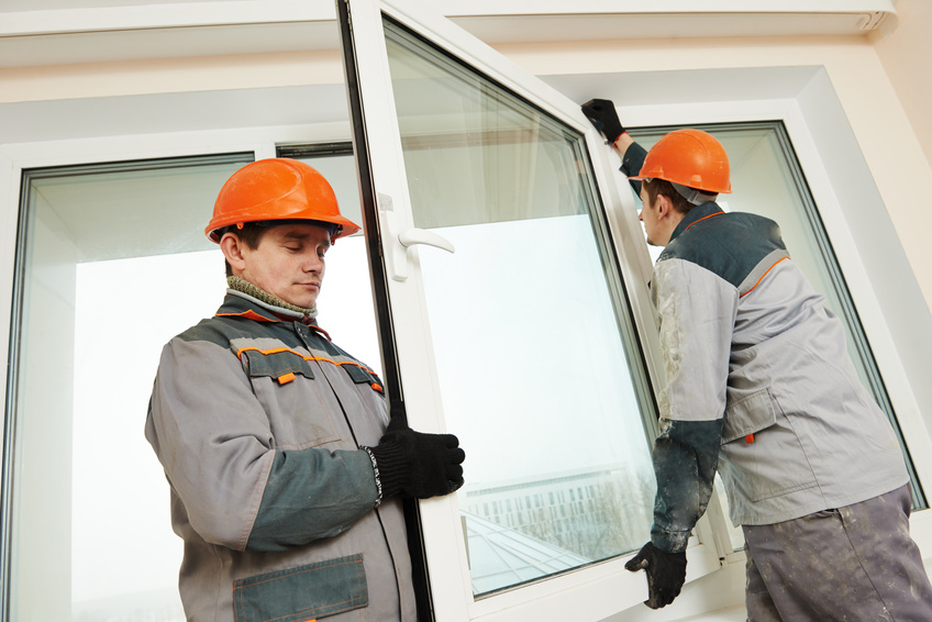 two workers installing window